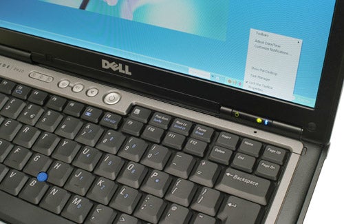 Dell Latitude D620 laptop with a focus on the keyboard and screen displaying the Windows desktop.