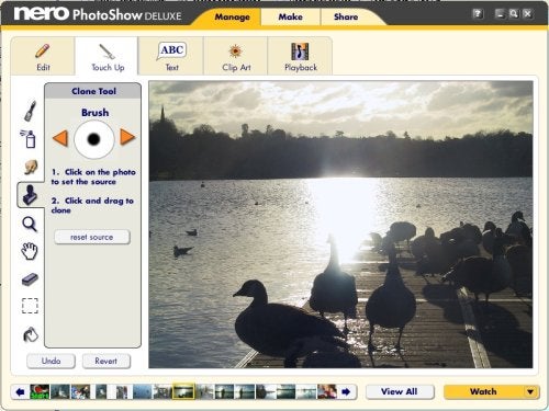 Screenshot of Nero PhotoShow Deluxe 4 software interface showing the editing tools and a photograph of ducks on a wooden dock against a backdrop of a waterbody during sunset.