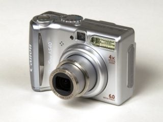 Canon PowerShot A540 digital camera displayed on a neutral background, highlighting its silver body, lens extended, and the 6.0-megapixels label visible on the front.