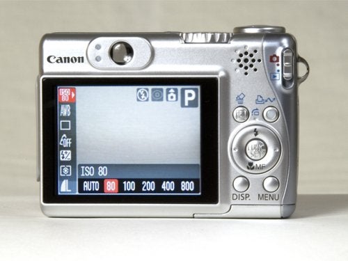 A Canon PowerShot A540 digital camera displayed with its LCD screen showing camera settings including ISO 80 and various modes.