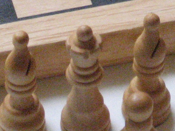 Close-up photo of chess pieces with shallow depth of field, likely taken with a Canon PowerShot A540 to demonstrate camera's macro photography capabilities.