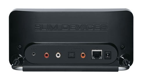 Back view of a black Slim Devices Squeezebox music player showing connectivity ports including audio out and Ethernet port.