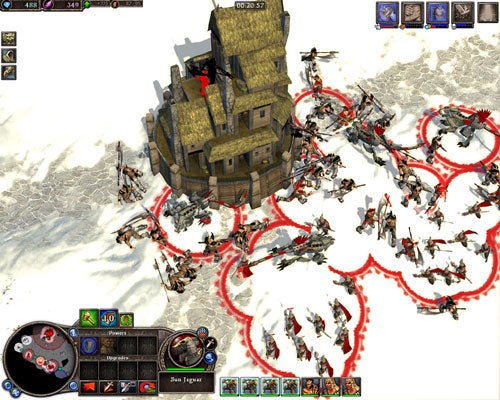 Screenshot of in-game action from Rise of Legends showing a stone tower being besieged by a group of units on a snowy terrain, with the game's user interface visible at the bottom and the top left corner.