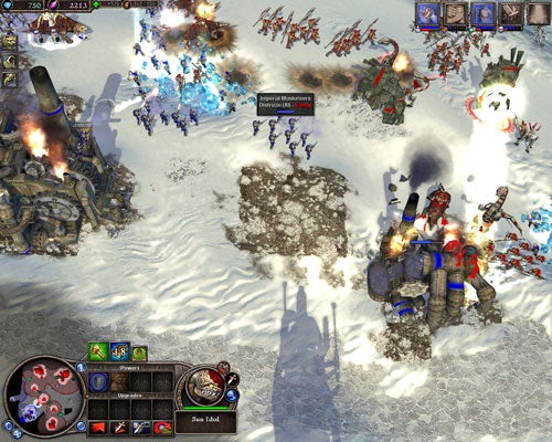 Screenshot of Rise of Legends video game showing a battle scene with various units and explosions, depicting the game's real-time strategy gameplay and its interface elements.