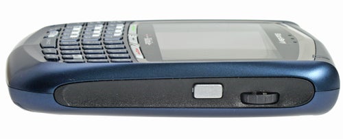Side view of a T-Mobile BlackBerry 8700 smartphone showcasing its QWERTY keyboard and scroll wheel.