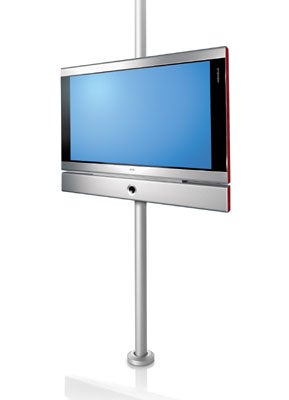 Loewe Individual 32 S 32-inch LCD TV on a stand with a blank screen, featuring a sleek silver and red design.
