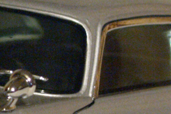 Close-up of a classic car's side mirror and chrome detailing exhibiting the high ISO noise performance of the Olympus E-330 Digital SLR.