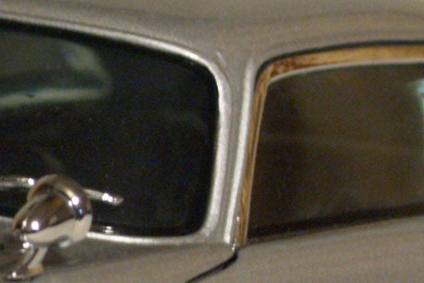 Close-up image of a car's side mirror, possibly taken to demonstrate the image quality of the Olympus E-330 Digital SLR camera.