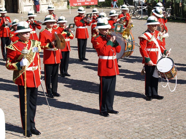 A brass band in uniform playing instruments during a public performance with a clear focus and good color representation, possibly demonstrating the image quality of the Olympus E-330 Digital SLR camera.