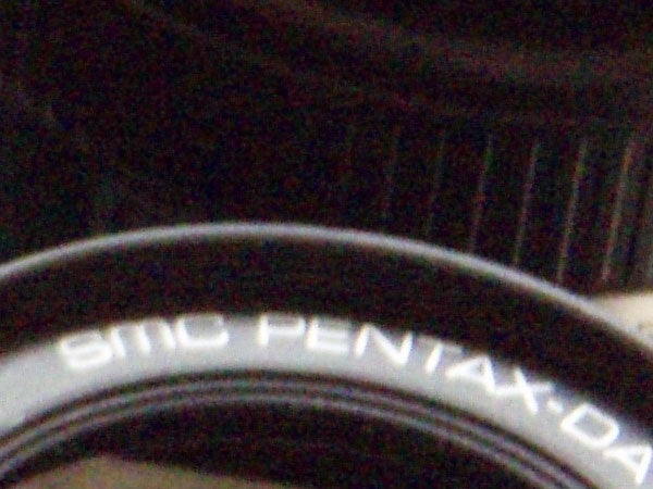 Close-up of a camera lens with the text 