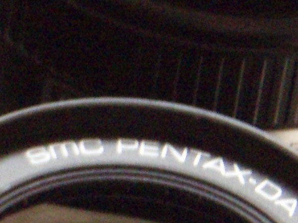 Close-up of a camera lens with the inscription 