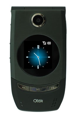 Qtek 8500 Windows Mobile 5 Smartphone with a digital clock displayed on the screen, featuring a flip design with external buttons and camera on a green background.