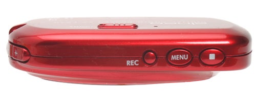 Side view of a red JVC Alneo XA-F57 MP3 player showing the record button, menu control, and play/pause button.