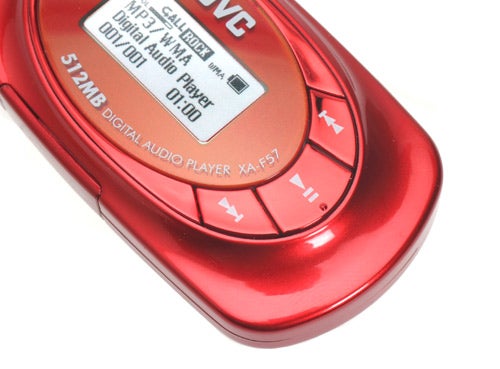 Red JVC Alneo XA-F57 MP3 player with a digital display showing the time and '512MB DIGITAL AUDIO PLAYER XA-F57' text, control buttons visible on side.