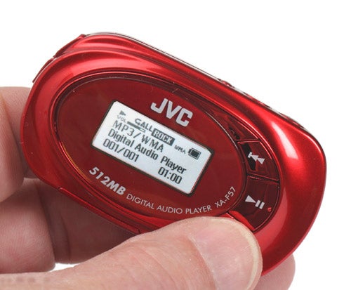 Close-up of a hand holding a JVC Alneo XA-F57 MP3 Player with a red casing displaying its screen and control buttons.