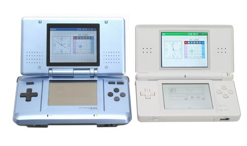Two Nintendo DS Lite handheld consoles open and displayed side by side, one in a metallic blue and the other in white, each showing a different game on the upper and lower screens.