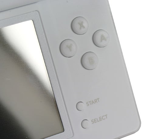Close-up of a white Nintendo DS Lite handheld console showing the A, B, X, Y buttons, and START and SELECT buttons next to the lower right side of the screen.