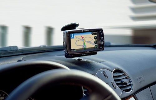 Navman iCN 720 satellite navigation system mounted on a car dashboard displaying a map with driving directions.