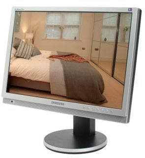 Samsung SyncMaster 215TW 21-inch LCD monitor displaying a sharp, vibrant image of a bedroom, with the brand logo visible on the bezel.