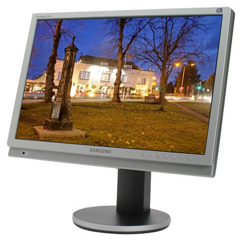 Samsung SyncMaster 215TW 21-inch monitor displaying a vibrant nighttime street scene, with monitor controls visible along the bottom bezel.