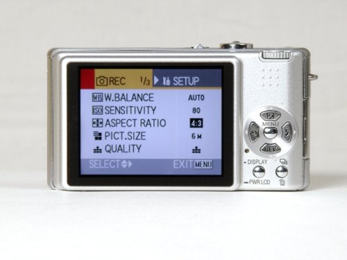 Rear view of a Panasonic Lumix DMC-FX9 digital camera showing the LCD screen with the setup menu options for white balance, ISO sensitivity, aspect ratio, picture size, and quality settings.