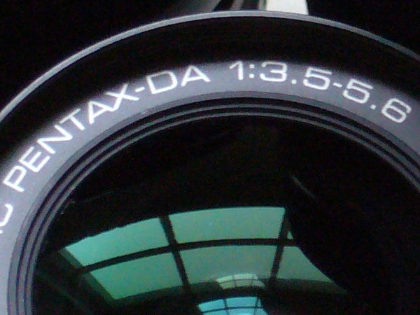 Close-up of a camera lens with the inscription 