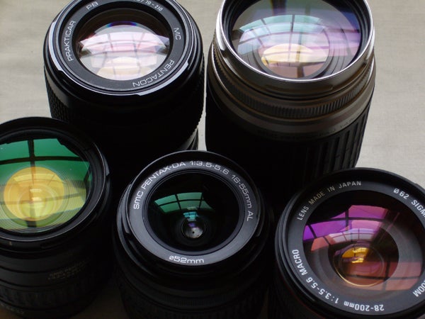 A collection of camera lenses with various focal lengths and apertures, possible accessories for cameras like the Panasonic Lumix DMC-FX9.