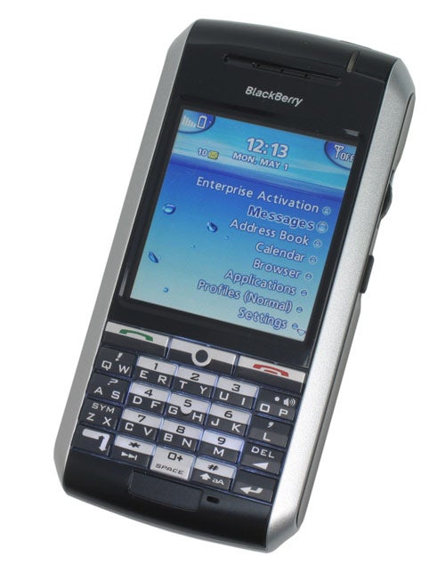 BlackBerry 7130g smartphone with a full QWERTY keyboard and a blue screen displaying the main menu including messages, calendar, and browser.