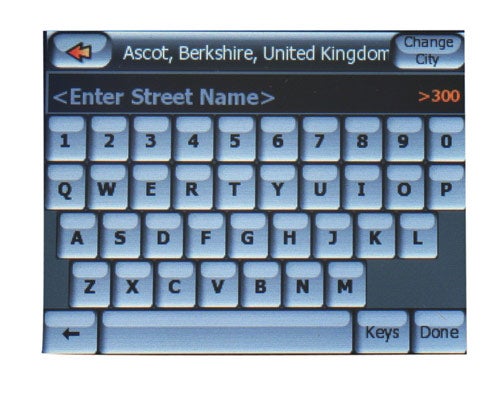 A Mio DigiWalker C710 GPS navigator screen showing a QWERTY keyboard interface with the option to enter a street name, indicating Ascot, Berkshire, United Kingdom as the current city.
