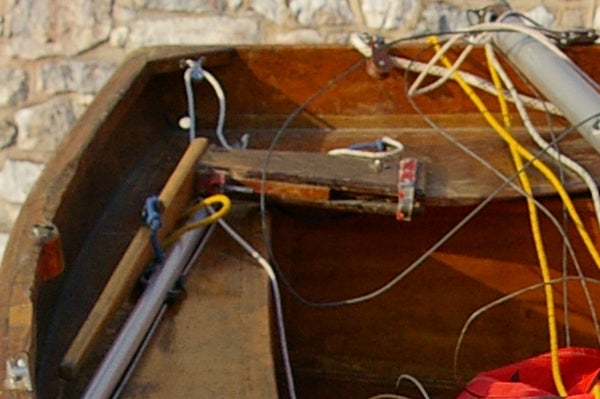 Close-up of camera equipment and wires inside a wooden compartment, possibly related to the setup or testing of the Pentax *ist DL2 Digital SLR camera.