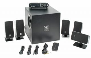 Logitech Z-5450 Wireless Speakers set including four satellite speakers, a center channel speaker, a subwoofer, cables, and a remote control displayed on a white background.