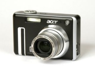 Acer CP-8660 digital camera with a silver lens barrel, large lens aperture, and branded with the Acer Precision Lens logo, positioned on a white background.