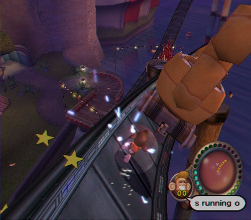 Screenshot of gameplay from Super Monkey Ball Adventure showing a character rolling inside a transparent ball on a narrow track above a fantasy-themed environment with floating platforms and stars.
