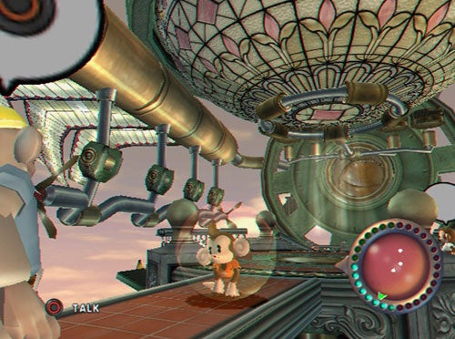 A screenshot from the video game Super Monkey Ball Adventure showing a character standing on a platform with intricate mechanical structures in the background and a conversation prompt on-screen.