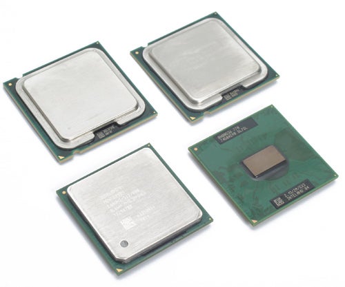 Four Intel Core 2 Duo processors positioned on a light surface, showing the top and bottom views with visible model information on the chips.