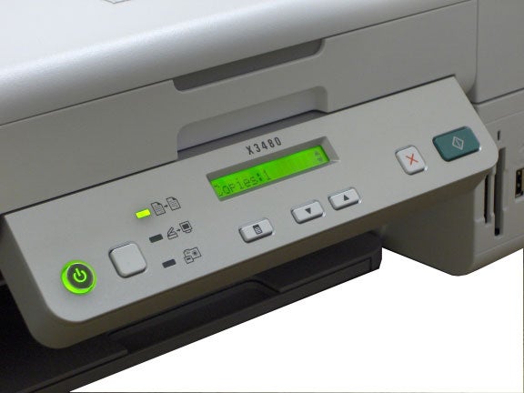 Close-up of Lexmark X3480 Multi-Function Printer control panel with illuminated green power button and LCD display showing model number.