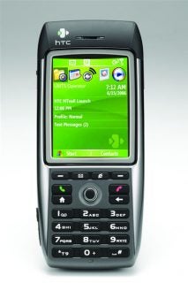 Product image showing the HTC MTeoR Windows Mobile 3G Smartphone with its screen displaying the home interface, featuring icons for various applications and services, and the phone's keypad visible below.