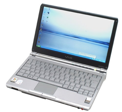 Sony VAIO VGN-TX3XP ultra-portable notebook open on a desk with screen displaying desktop wallpaper and taskbar, showcasing the full keyboard and touchpad.
