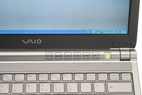 Close-up of the Sony VAIO VGN-TX3XP ultra-portable notebook keyboard and hinge, showing part of the screen, with the VAIO logo and model number clearly visible.