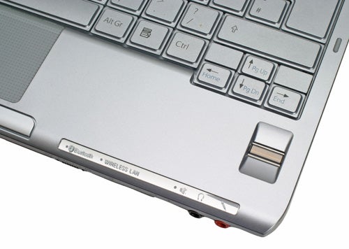 Close-up of Sony VAIO VGN-TX3XP ultra-portable notebook's keyboard and trackpad area, showing the Bluetooth and wireless LAN status indicators.
