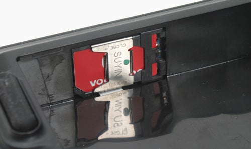 Close-up of the SIM card slot in an Acer Aspire 5650 3G laptop with a SIM card inserted.