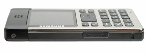 A Samsung SGH-P300 mobile phone shown from a side angle, highlighting its slim profile, with the screen and keypad facing upward.