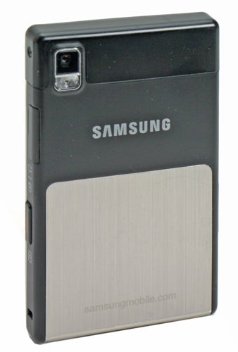 A Samsung SGH-P300 super slim mobile phone with a silver and black color scheme, featuring a camera lens and flash at the top right corner and a metallic texture on the lower half.
