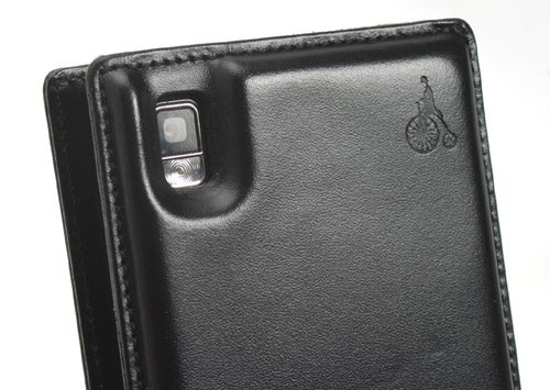 Samsung SGH-P300 mobile phone in a black leather case with a camera lens visible at the top.
