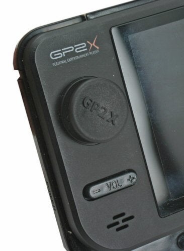 Close-up of a black GP2X Personal Entertainment Player focusing on the volume control and part of the screen.