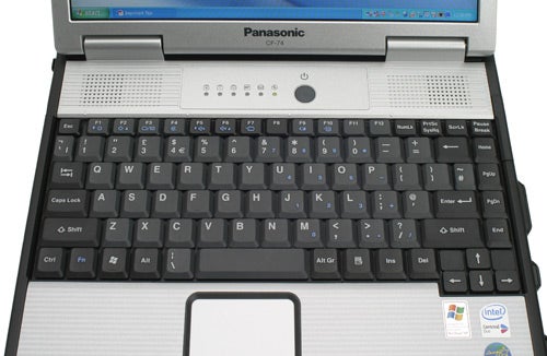 Close-up view of a Panasonic Toughbook CF-74 keyboard and touchpad, showing the rugged design with a partially visible screen and status LEDs above the keyboard.
