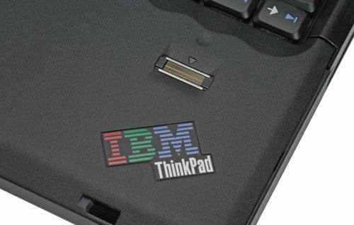 Close-up of the Lenovo IBM ThinkPad T60p laptop showing the IBM logo and ThinkPad branding on the palm rest.