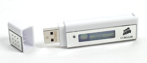 White Corsair Flash Readout USB memory key with a digital display showing the storage capacity, USB connector visible to the side with protective cap detached.