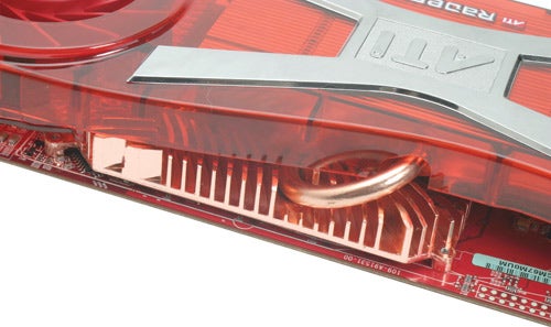Close-up of a red ATI Radeon X1950 XT-X graphics card showing heatsink fins and part of the printed circuit board.