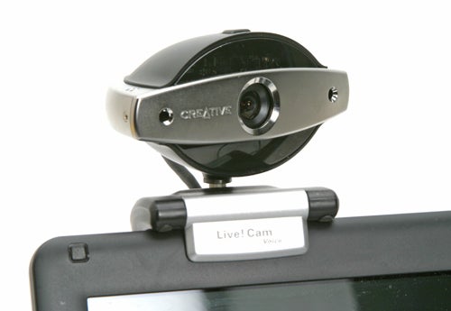 A Creative Live! Cam Voice webcam mounted on top of a computer monitor, showing the front-facing lens and built-in microphone design.